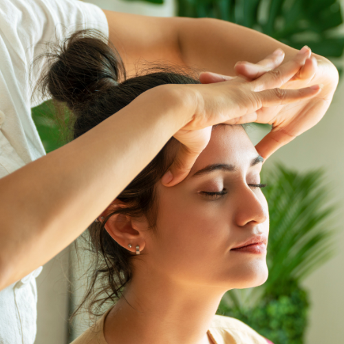 Employee receiving a relaxing Indian head massage in an office setting.