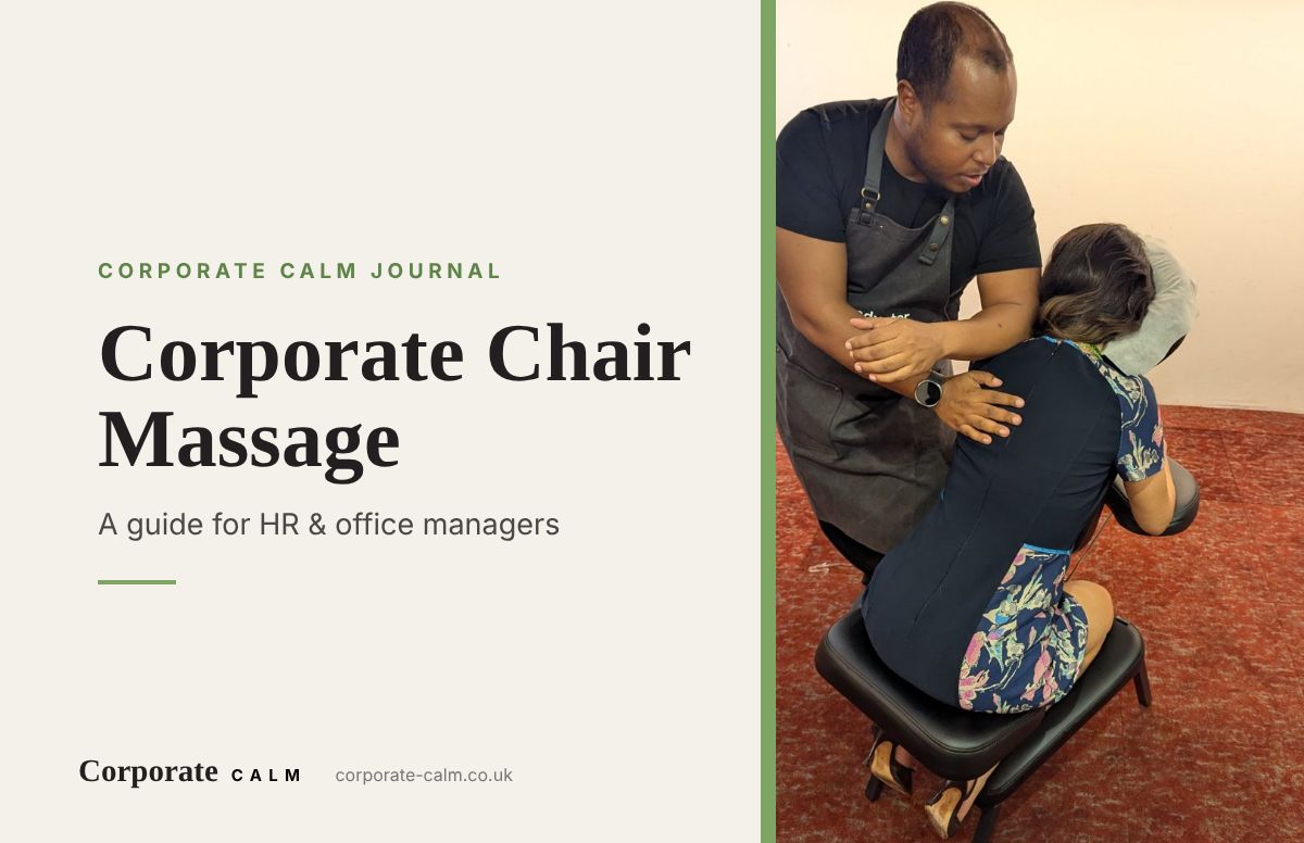 Massage therapist giving a fully-clothed chair massage to an employee in office clothes