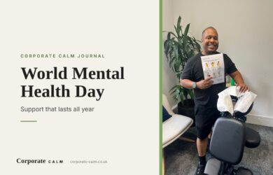 Smiling Corporate Calm massage therapist holding a desk stretches guide next to his massage chair